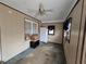 View of empty room with paneling, ceiling fan, window, with boxes sitting near wall at 1643 Westhaven Sw Dr, Atlanta, GA 30311