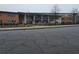 An exterior view of the school with a metal fence in front and bare trees on a cloudy day at 1643 Westhaven Sw Dr, Atlanta, GA 30311