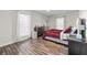 Spacious bedroom with wood floors, large window and dresser at 6851 Roswell Rd # F35, Atlanta, GA 30328