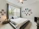 Bright bedroom featuring a comfortable platform bed and large window at 775 Stickley Oak Way, Woodstock, GA 30189