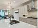 Modern kitchen with white cabinets, granite counters and breakfast bar at 775 Stickley Oak Way, Woodstock, GA 30189