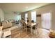 Open concept dining room with hardwood floors, a table for six and views into the living room at 2757 Malton Way, Loganville, GA 30052