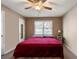 Spacious bedroom with a red blanket and ceiling fan at 51 Willow Bend Nw Dr, Cartersville, GA 30121