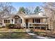 Inviting yellow house with a wraparound porch and landscaped yard at 51 Willow Bend Nw Dr, Cartersville, GA 30121