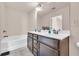 Bathroom with a double vanity, soaking tub, and tile floor at 5531 Pine Aly, Lithonia, GA 30058