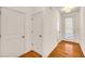 Light and airy entryway with hardwood floors and white walls at 5531 Pine Aly, Lithonia, GA 30058