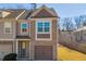 Brick front townhouse with 2-car garage and landscaped yard at 5531 Pine Aly, Lithonia, GA 30058