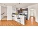 Open concept kitchen island with breakfast bar and hardwood floors at 5531 Pine Aly, Lithonia, GA 30058