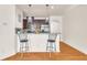 Kitchen island with seating, hardwood floors, and modern finishes at 5531 Pine Aly, Lithonia, GA 30058