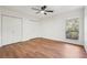 Well-lit bedroom with wood floors, ceiling fan and large window at 622 Powers Ferry North Se, Marietta, GA 30067