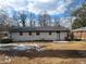 Ranch home with white brick exterior and backyard at 4664 Ryan Rd, Conley, GA 30288