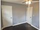 Bedroom with dark hardwood floors and two white doors at 4664 Ryan Rd, Conley, GA 30288