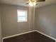 Spacious bedroom with dark hardwood floors and ceiling fan at 4664 Ryan Rd, Conley, GA 30288