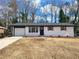 Charming ranch home with white brick exterior, new roof and landscaping at 4664 Ryan Rd, Conley, GA 30288