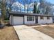 Updated ranch home with white brick exterior, new roof and driveway at 4664 Ryan Rd, Conley, GA 30288