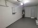 Garage with gray epoxy floor, water heater and door at 4664 Ryan Rd, Conley, GA 30288