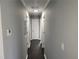 Long hallway with dark hardwood floors and neutral gray walls at 4664 Ryan Rd, Conley, GA 30288