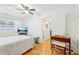 Bedroom with hardwood floors, ceiling fan, and built-in TV stand at 885 Briarcliff Ne Rd # 21, Atlanta, GA 30306