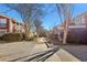 A view of the community walkway with mature trees and landscaping leading to brick buildings at 885 Briarcliff Ne Rd # 21, Atlanta, GA 30306