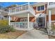Charming brick building with white trim, balcony and porch with walkway to black-framed glass entry door at 885 Briarcliff Ne Rd # 21, Atlanta, GA 30306