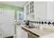 White kitchen cabinets, stainless steel appliances, and a green accent wall at 885 Briarcliff Ne Rd # 21, Atlanta, GA 30306