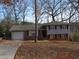 Brick ranch house with attached garage and mature trees at 2491 Crestdale Se Cir, Atlanta, GA 30316