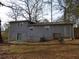 Rear view of home with sliding glass door and small deck at 2491 Crestdale Se Cir, Atlanta, GA 30316