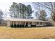 Ranch home with metal roof, front porch, and manicured lawn at 39 Lake Dr, Bowdon, GA 30108