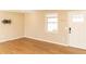 Living area showcasing light hardwood floors, neutral walls, and a window at 39 Lake Dr, Bowdon, GA 30108