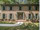 Two-story brick home with green shutters and a welcoming entrance at 2982 Huntshire Pl, Atlanta, GA 30340