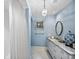 Light blue bathroom with white vanity and marble countertop at 23 Paces West, Atlanta, GA 30327