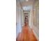 Long hallway with hardwood floors and classic trim at 23 Paces West, Atlanta, GA 30327