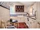 Bright kitchen with white cabinets, blue tile, and a farmhouse sink at 23 Paces West, Atlanta, GA 30327