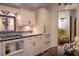 White kitchen with blue tile backsplash, gas range and built-in refrigerator at 23 Paces West, Atlanta, GA 30327