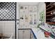 White kitchen with glass-front cabinets, blue tile, and ample counter space at 23 Paces West, Atlanta, GA 30327