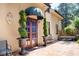 Inviting stone patio with a charming entrance, lush greenery, and wrought iron accents at 23 Paces West, Atlanta, GA 30327