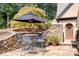 Stone patio with seating area and umbrella at 23 Paces West, Atlanta, GA 30327