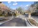 View of the gated community entrance with landscaped grounds, brick pillars, and blooming flowers for a welcoming feel at 23 Paces West Dr, Atlanta, GA 30327