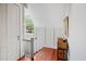 Hallway with a white door, white wainscoting, and a wood floor, leading to a window at 23 Paces West Dr, Atlanta, GA 30327