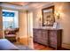 Bedroom featuring a dresser with a mirror, a chair, a window, and a hardwood floor at 23 Paces West Dr, Atlanta, GA 30327