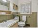 Simple bathroom with a sink, toilet, and green tiled walls at 3251 Wanda Woods Dr, Atlanta, GA 30340