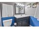 Clean bathroom with dark vanity, updated fixtures, and blue wainscoting at 3251 Wanda Woods Dr, Atlanta, GA 30340