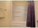 Simple bathroom with a shower/tub combo and purple shower curtain at 4163 Citizen Cir, Austell, GA 30106