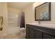 Updated bathroom with a shower/tub combo and dark vanity at 4163 Citizen Cir, Austell, GA 30106