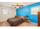 Bright bedroom featuring a brown comforter and blue accent wall at 4163 Citizen Cir, Austell, GA 30106