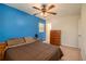 Spacious bedroom with a brown comforter and blue accent wall at 4163 Citizen Cir, Austell, GA 30106