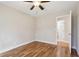 Hardwood floor bedroom with ceiling fan and access to bathroom at 2610 Old Covington Ne Rd, Conyers, GA 30013