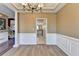 Formal dining room with hardwood floors, chair railing, and access to the kitchen at 513 Mirramont Place, Woodstock, GA 30189