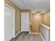 Upstairs hallway with two doors and wood-look floors at 513 Mirramont Place, Woodstock, GA 30189