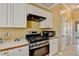 Modern kitchen with stainless steel gas range and microwave at 513 Mirramont Place, Woodstock, GA 30189